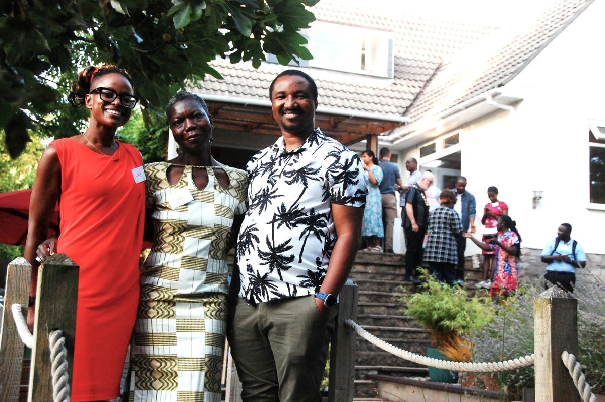 The three BPNS founders on the garden path, with guests gathered on the steps behind them.