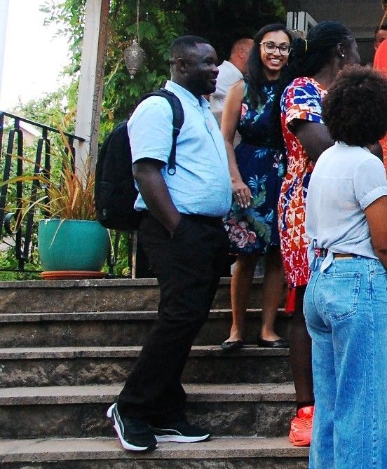Guests arriving and greeting one another on the steps at the launch.